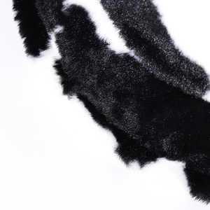 Chic black and white cow print faux fur bucket hat with soft plush texture for winter
