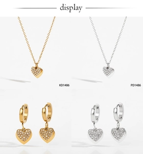 Detailed view of heart-shaped jewelry set with necklace and zircon inlaid hoop earrings