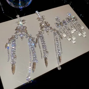 Sparkling silver fringe earrings with geometric leaf design and rhinestone tassels