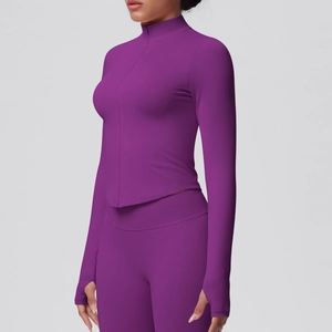Close-up detail of the thumbhole cuff and ribbed texture on purple yoga jacket sleeve