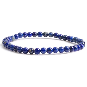 Macro detail of 6mm natural lapis lazuli round beaded elastic bracelet with gold flecks
