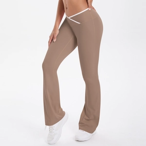 Detail of high-waist flared yoga pants with V-cross waistband and white contrast trim