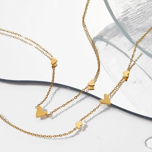 Elegant gold stainless steel necklace featuring multiple heart charms on a white background