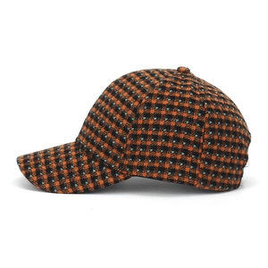 Side view of checkered baseball cap with orange and black tweed texture detail