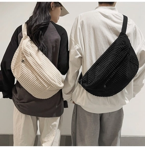 Detailed view of corduroy crossbody bags in beige and black shown on male and female models