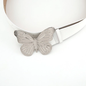 Close-up of white leather belt featuring a large silver metal butterfly buckle detail