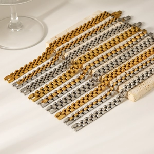 Polished titanium steel watch band bracelets in gold and silver finish on stone base