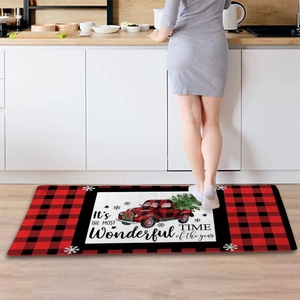 Detailed view of red buffalo plaid Christmas runner mat with vintage truck and holiday text