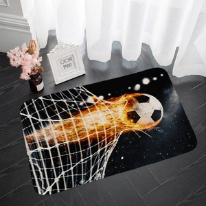 Detailed close-up of a soccer flame pattern flannel absorbent mat on dark wooden floor