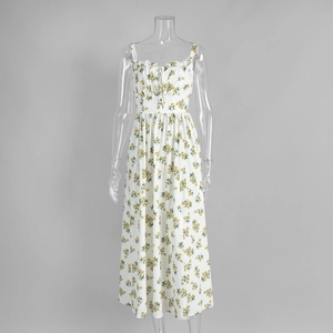 Close-up of yellow lemon and green leaf print on a white floral sun dress detail