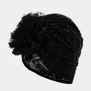 Detailed view of black lace turban featuring floral embroidery and sequins with mesh texture