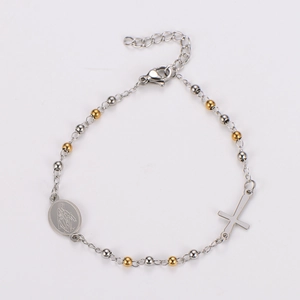 Detail of silver rosary bracelet with golden beads, cross pendant and Mary medal