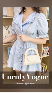 Chic cream white lychee pattern mini bag with gold chain strap worn by a model