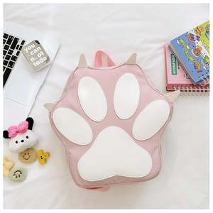 Detail shot of a cute pink cat paw backpack with white paw pads and durable nylon fabric
