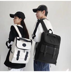 Rear view of black and off-white high-density nylon backpacks worn by male and female models
