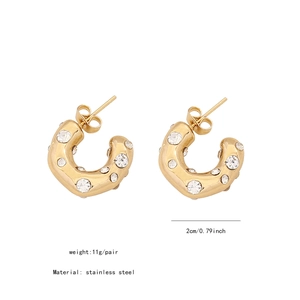 Detailed macro view showing a 2cm diameter gold C-shaped stainless steel bow earring