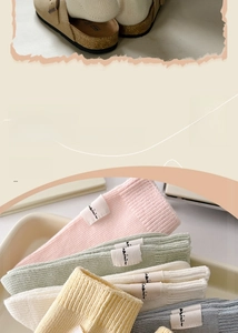 Detail of macaron-colored cotton socks with knit texture and stylish fabric labels
