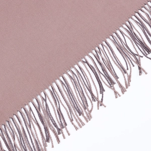 Close-up of fringe details on a soft pink-purple cashmere scarf with wool texture