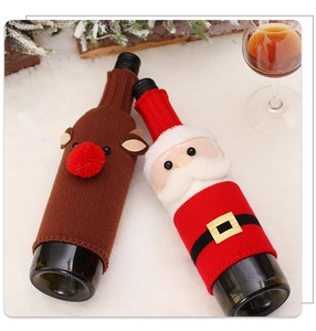 Festive knitted wine bottle covers with Santa Claus and reindeer on a snow background