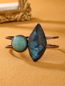 Macro view of vintage copper bracelet with natural green amazonite and labradorite stone