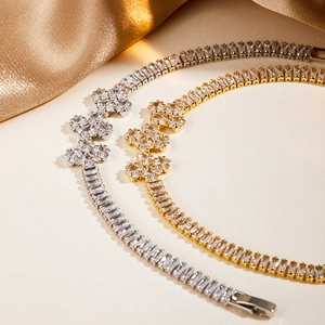 Detailed shot of clover tennis bracelets in gold and silver finish with zircon stones
