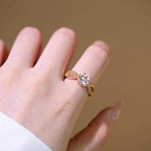 Elegant gold infinity ring featuring an oval centerpiece and pavé-set accents for women