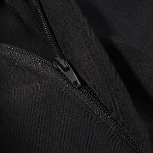 Macro shot of high-quality black zipper closure and textured fabric on stylish jacket