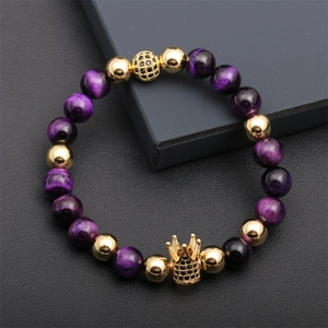 Detail of beaded crown bracelet with purple tiger eye stones and gold accents