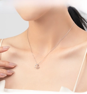 Model wearing a delicate S925 silver hollow heart necklace with sparkling zircon pavé