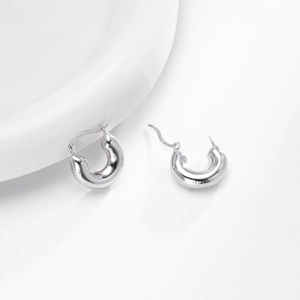 Detailed macro view of 925 sterling silver hallmark on polished hoop earrings