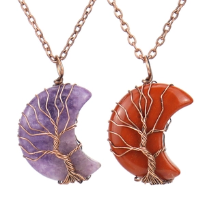Detail of handmade copper wire-wrapped tree of life pendant with crescent natural stones