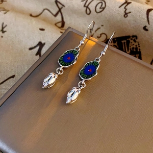 Close-up of enamel lotus leaf earrings with blue and green dripping oil finish
