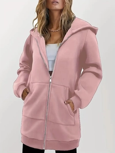 Close-up of pink zip-up hoodie featuring oversized pockets and drop-shoulder design
