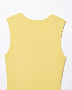 Close-up of yellow knit sleeveless dress showing round neckline and premium texture