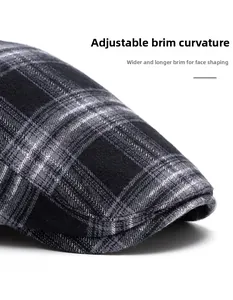 Close-up of black and white plaid newsboy hat featuring a foldable wide brim design