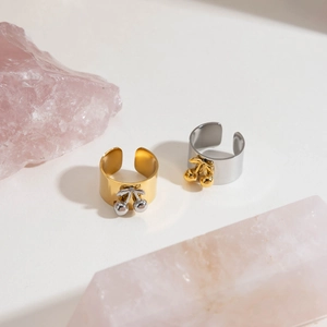Detail of adjustable stainless steel cherry rings on pink crystals for women