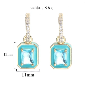Detail view of 18K gold earrings featuring blue zircon and turquoise enamel with dimensions