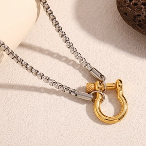 Detailed close-up of the two-tone stainless steel chain with a gold U-shaped screw clasp