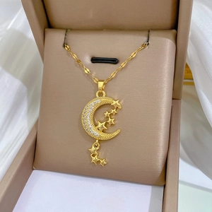 Macro shot of gold star and moon tassel necklace with sparkling cubic zirconia inlay