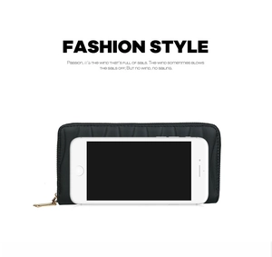 Black long PU leather wallet with wavy quilting shown next to a smartphone for scale