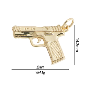 Detailed close-up of golden pistol charm showing 20mm x 14.2mm dimensions and Smith engraving