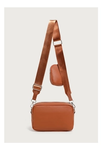 Brown quilted crossbody bag detail with adjustable strap and small round coin purse
