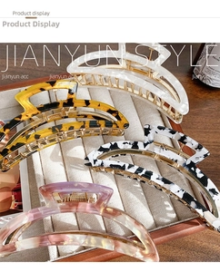 Close-up of four acetate hair claws in tortoise shell and marble patterns on velvet
