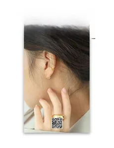 Minimalist gold hoop earrings and wide polished ring set shown on a female model