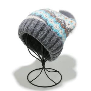 Detailed knit pattern on winter Fair Isle beanie with pom-pom and ribbed edge