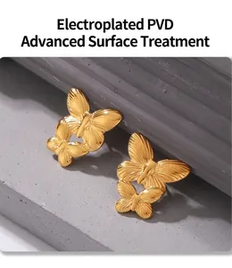 Macro shot of 18k gold plated PVD butterfly earring on a dark textured rock background