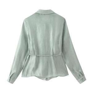Detail view of mint green satin shirt back featuring adjustable waist drawstring and smooth texture