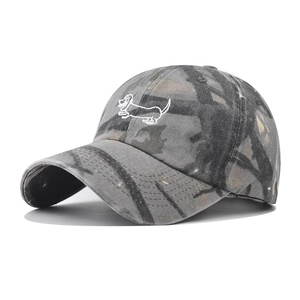 Makroansicht der weißen Hundebestickung auf der verwaschenen Camouflage-Baseballkappe