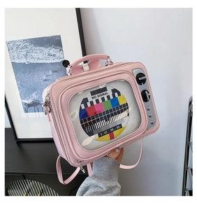Close-up of pink vintage TV-shaped backpack with no-signal screen and metallic knobs