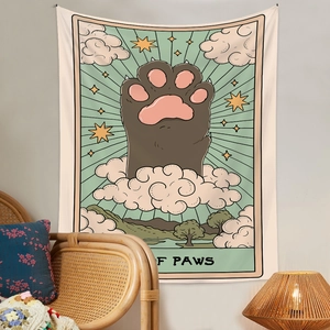 Close-up of cat paw tarot tapestry with cosmic cloud design in a cozy bohemian room